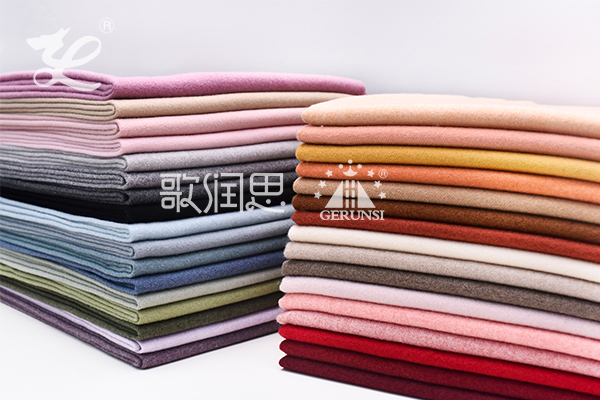 How should wool scarves be cleaned?